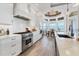 Modern kitchen with stainless appliances, white cabinets, a breakfast nook, and wood-look tile flooring at 565 Green Dolphin S Dr, Placida, FL 33946