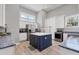 Bright laundry room with white cabinets, stainless steel appliances, and a center island at 565 Green Dolphin S Dr, Placida, FL 33946