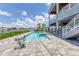 Beautiful pool with attached spa overlooks a serene waterfront view and is surrounded by a spacious deck at 565 Green Dolphin S Dr, Placida, FL 33946