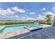 Beautiful pool with attached spa overlooks a serene waterfront view and is surrounded by a spacious deck at 565 Green Dolphin S Dr, Placida, FL 33946