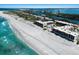 Aerial shot of luxury condos on white sand beach, turquoise waters, and serene coastal living at 5700 Gulf Shores Dr # B-137, Boca Grande, FL 33921