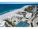 Stunning aerial view of beachside condos, a pool, tennis courts, and pristine coastline in the background at 5700 Gulf Shores Dr # B-137, Boca Grande, FL 33921