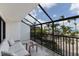 Relaxing screened-in balcony with comfortable seating and beautiful views of the beach at 5700 Gulf Shores Dr # B-137, Boca Grande, FL 33921