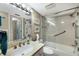 Updated bathroom featuring a bathtub with glass door, bright lighting, and neutral tones at 5700 Gulf Shores Dr # B-137, Boca Grande, FL 33921