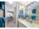 Cozy bathroom with vanity, sink, and views of the Primary bedroom with a beachy theme at 5700 Gulf Shores Dr # B-137, Boca Grande, FL 33921