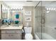Updated bathroom featuring a bathtub with glass door, bright lighting, and neutral tones at 5700 Gulf Shores Dr # B-137, Boca Grande, FL 33921