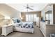 This charming bedroom features a ceiling fan and lots of white furniture including two dressers and two nightstands at 5700 Gulf Shores Dr # B-137, Boca Grande, FL 33921