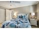 This is a bedroom with a nautical theme, featuring a ceiling fan, two dressers, and an attached bathroom at 5700 Gulf Shores Dr # B-137, Boca Grande, FL 33921