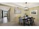 Dining room featuring a modern chandelier and a black table setting for four at 5700 Gulf Shores Dr # B-137, Boca Grande, FL 33921
