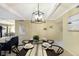 Open dining area with black table and chairs adjacent to the spacious living area at 5700 Gulf Shores Dr # B-137, Boca Grande, FL 33921