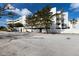 Modern condominium complex showcasing clean lines and white facade, nestled near a sandy beach and blue sky at 5700 Gulf Shores Dr # B-137, Boca Grande, FL 33921