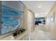 Inviting hallway with neutral tones, tile flooring, and an ocean-themed artwork at 5700 Gulf Shores Dr # B-137, Boca Grande, FL 33921