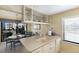 Open kitchen layout with breakfast bar, views of the dining area, and seaside decor at 5700 Gulf Shores Dr # B-137, Boca Grande, FL 33921
