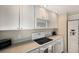 Functional kitchen with white appliances, ample storage, and neutral countertops at 5700 Gulf Shores Dr # B-137, Boca Grande, FL 33921