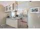 Cozy kitchen featuring white cabinetry, breakfast bar, and modern appliances at 5700 Gulf Shores Dr # B-137, Boca Grande, FL 33921