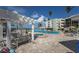 Beautiful pool area featuring a sparkling blue pool, comfortable lounge seating, and scenic views of the property at 5700 Gulf Shores Dr # B-137, Boca Grande, FL 33921