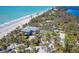 Aerial view featuring a charming coastal home with easy access to a pristine beach at 6430 Manasota Key Rd, Englewood, FL 34223