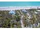 Coastal property featuring houses with private beach access surrounded by mature trees at 6430 Manasota Key Rd, Englewood, FL 34223