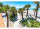 Charming home features sandy backyard with palm trees and stone walkway at 6430 Manasota Key Rd, Englewood, FL 34223