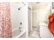 A bright bathroom is complete with double sinks, white cabinets, tile floors and a tub with shower at 6430 Manasota Key Rd, Englewood, FL 34223