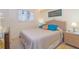 Cozy bedroom with a queen bed, rattan accents, and a soothing color scheme for relaxation at 6430 Manasota Key Rd, Englewood, FL 34223