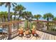 Charming deck features ocean view, tropical landscaping, and wooden pelican decorations at 6430 Manasota Key Rd, Englewood, FL 34223