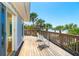 An exterior deck with beach views, a white seating set and palm trees at 6430 Manasota Key Rd, Englewood, FL 34223