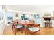 Elegant dining area with hardwood floors, ocean views, and seamless transition to the living room at 6430 Manasota Key Rd, Englewood, FL 34223
