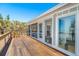 Beautiful home featuring large windows, spacious wooden deck, and a screened-in porch at 6430 Manasota Key Rd, Englewood, FL 34223