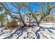 Charming home exterior featuring a well-maintained yard, complemented by mature trees for added privacy and appeal at 6430 Manasota Key Rd, Englewood, FL 34223