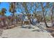 Home exterior featuring mature trees, a well-maintained yard, and a deck, offering a serene outdoor living space at 6430 Manasota Key Rd, Englewood, FL 34223