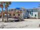 Charming home with an elevated deck, red chairs, views, and neutral paint at 6430 Manasota Key Rd, Englewood, FL 34223