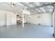 Spacious garage featuring utility sink, washer, dryer, storage cabinets, and bright natural light at 6430 Manasota Key Rd, Englewood, FL 34223