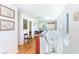 Bright hallway with hardwood floors, white walls, and natural light, creating an open feel at 6430 Manasota Key Rd, Englewood, FL 34223