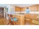 Kitchen with stone countertops, stainless steel appliances, hardwood floors and wooden barstools at 6430 Manasota Key Rd, Englewood, FL 34223