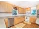 Well-lit kitchen with stainless steel dishwasher, lots of storage and hardwood floors at 6430 Manasota Key Rd, Englewood, FL 34223