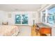 Light-filled main bedroom features desk, ocean view, and sliding doors to balcony at 6430 Manasota Key Rd, Englewood, FL 34223