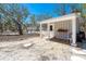Outbuilding with covered patio, potted plants and gravel landscaping in a natural setting at 6430 Manasota Key Rd, Englewood, FL 34223