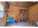 Outbuilding interior with tools hanging on wall, bags of soil, and outdoor equipment at 6430 Manasota Key Rd, Englewood, FL 34223