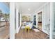 Inviting porch featuring comfortable seating and screened windows for enjoying tropical views at 6430 Manasota Key Rd, Englewood, FL 34223