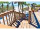 Wooden stairs descend to a pristine beach, framed by lush greenery and leading to turquoise waters at 6430 Manasota Key Rd, Englewood, FL 34223