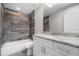 Modern bathroom boasts a granite vanity, decorative tile shower, and contemporary fixtures for comfort at 8270 Cook Ct, Port Charlotte, FL 33981
