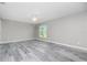 Bright bedroom with plank flooring, ceiling fan, and a view of the outdoors at 8270 Cook Ct, Port Charlotte, FL 33981