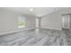 Inviting bedroom featuring modern plank floors, a ceiling fan, and a bright window at 8270 Cook Ct, Port Charlotte, FL 33981