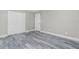 An airy bedroom showcases modern gray wood-look floors, white trim and closet with white doors at 8270 Cook Ct, Port Charlotte, FL 33981
