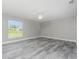 Serene bedroom with plank floors, ample natural light, and a ceiling fan at 8270 Cook Ct, Port Charlotte, FL 33981