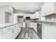 Bright kitchen with white cabinets, granite countertops, stainless steel appliances, and plank flooring at 8270 Cook Ct, Port Charlotte, FL 33981