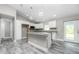 This modern kitchen features white cabinets, granite counters, and a breakfast bar for added convenience at 8270 Cook Ct, Port Charlotte, FL 33981
