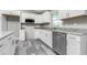 Bright kitchen with white cabinets, granite counters, and stainless steel appliances, offering a modern cooking space at 8270 Cook Ct, Port Charlotte, FL 33981
