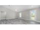 Spacious living room with modern plank flooring, ceiling fan, and natural light from the yard at 8270 Cook Ct, Port Charlotte, FL 33981